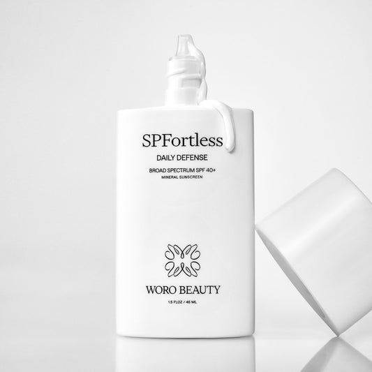 SPFortless Mineral SPF 40+ Daily Defense sunscreen bottle by Woro Beauty on light gray background
